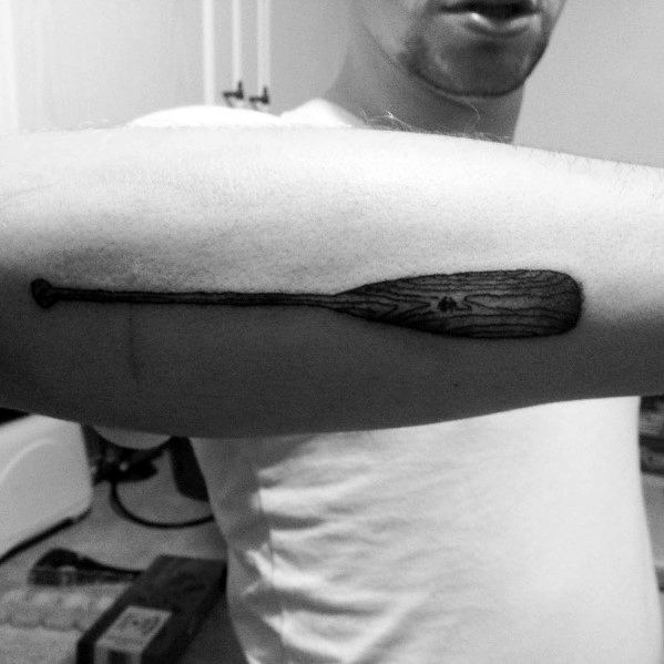 Realistic wooden paddle tattoo on the forearm, featuring fine details and wood grain texture, symbolizing adventure and a love for the water.