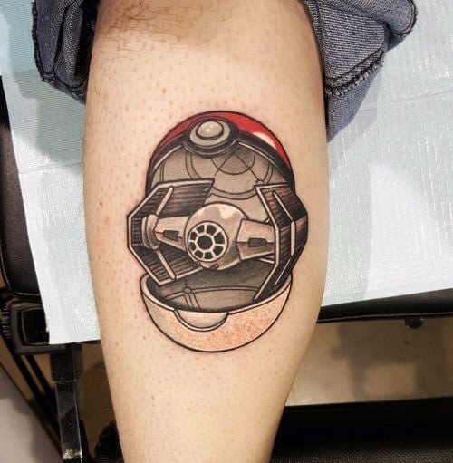 Unique Pokeball tattoo fused with a Star Wars TIE Fighter, combining geek fandoms in a bold, shaded design on the calf.