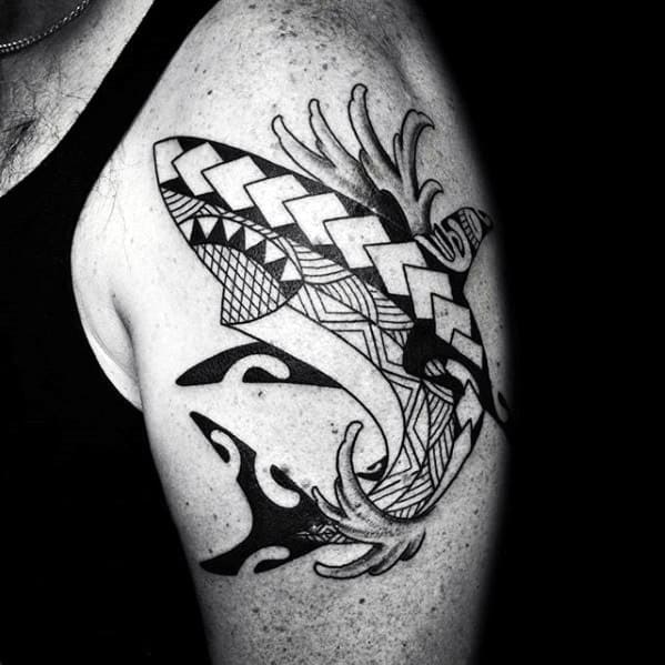 Polynesian shark tattoo on upper arm with bold tribal patterns and flowing lines symbolizing strength, resilience, and guidance.