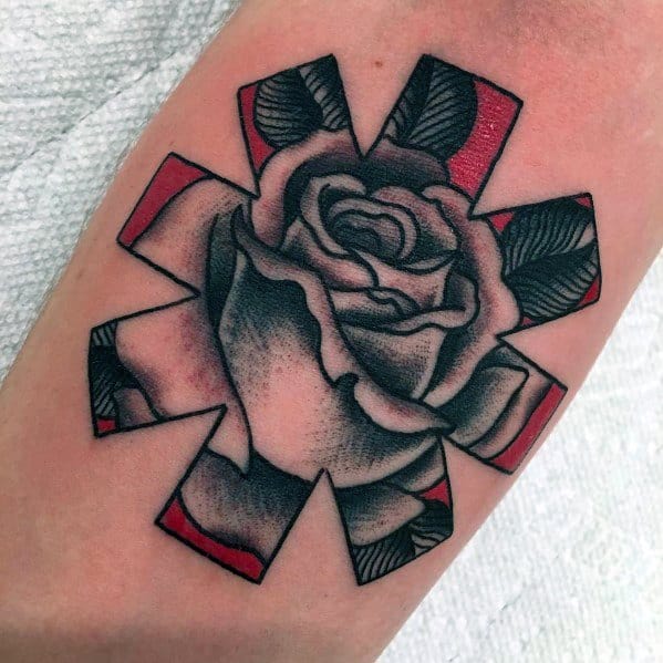 Tattoo featuring the Red Hot Chili Peppers logo with a detailed black and grey rose inside, accented by red edges for a bold and artistic look.