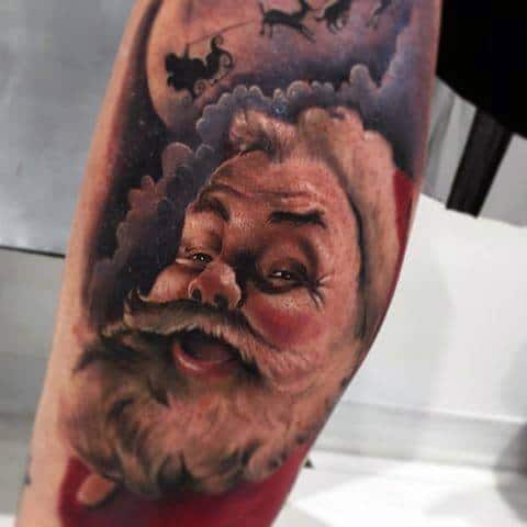 Hyper-realistic Santa Claus tattoo with lifelike shading, expressive eyes, and a festive background featuring his sleigh flying across the moon.