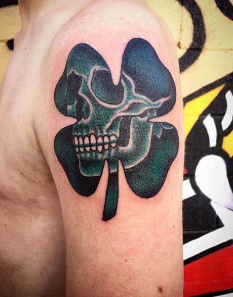 Creative Skull Inside 4 Leaf Clover Tattoo Designs On Mans Upper Arm