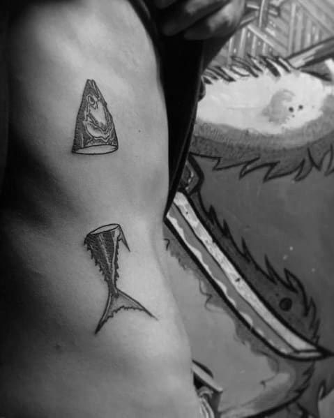Unique tuna fish head and tail tattoo on a man's side, featuring a bold and minimalist design with clean black ink and sharp details.