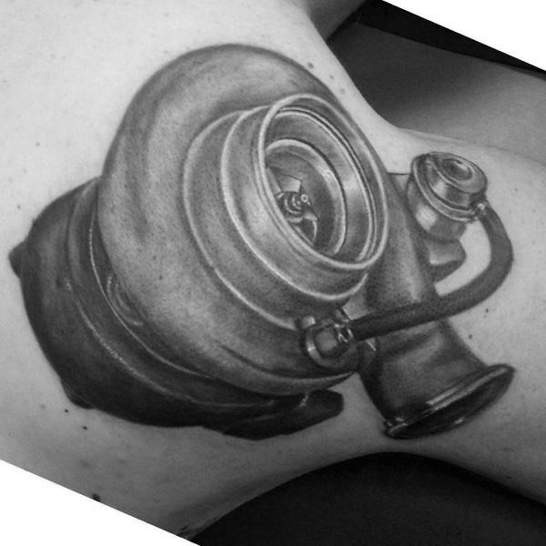 Realistic turbocharger tattoo on the upper arm with fine shading and intricate details, symbolizing speed, power, and a passion for automotive performance.