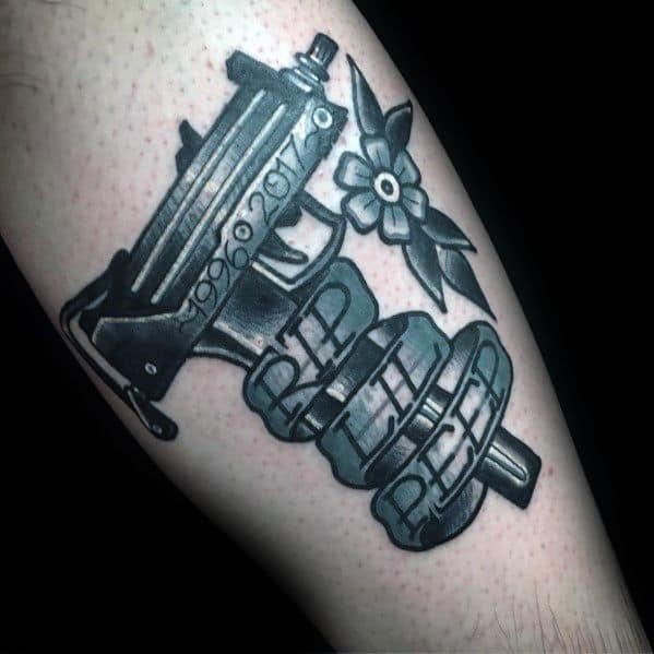 Black and grey Uzi tattoo with 'RIP LIL PEEP' on a scroll, a flower, and dates engraved on the gun. Memorial-style design.
