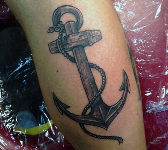 Tattoo of a detailed anchor with rope intertwined around it