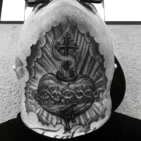 Black and gray throat tattoo of a sacred heart wrapped in barbed wire, with a cross and radiant background for a powerful spiritual design