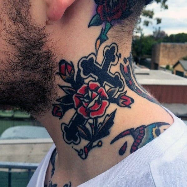 Traditional-style neck tattoo of a black cross with a vibrant red rose and green leaves wrapped around it, extending toward the jawline.