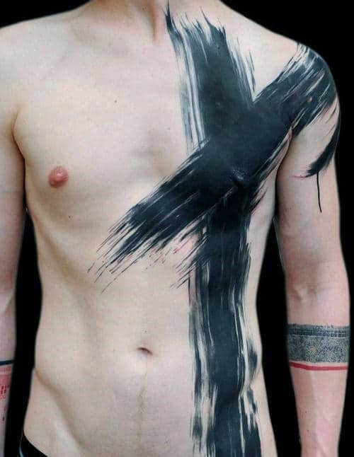 Upper body with black paint on chest and arm, forming an abstract cross shape