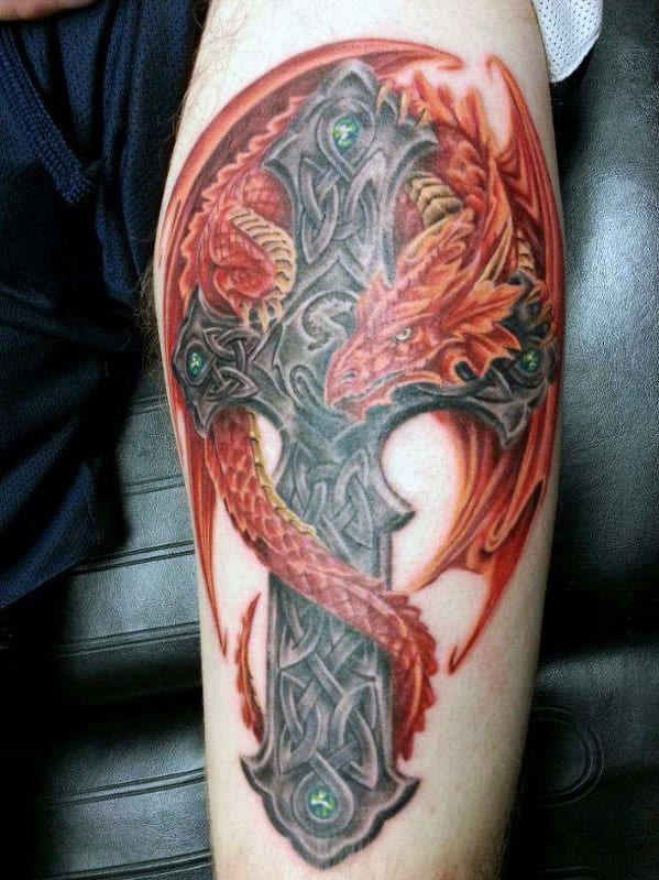 Tattoo of a red dragon wrapped around a Celtic cross with intricate designs