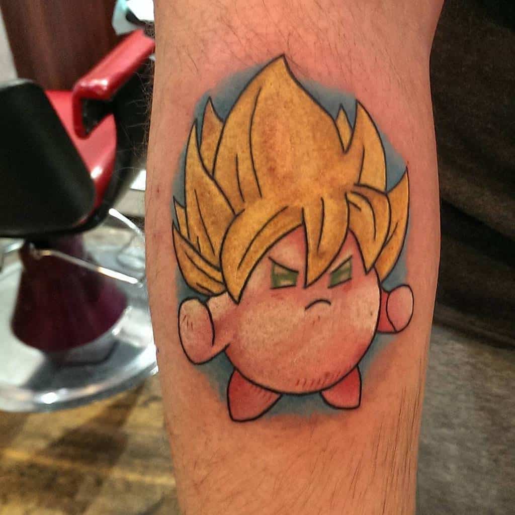 Kirby tattoo styled as a Super Saiyan with spiky golden hair and green eyes, a bold fusion of Dragon Ball and Kirby characters