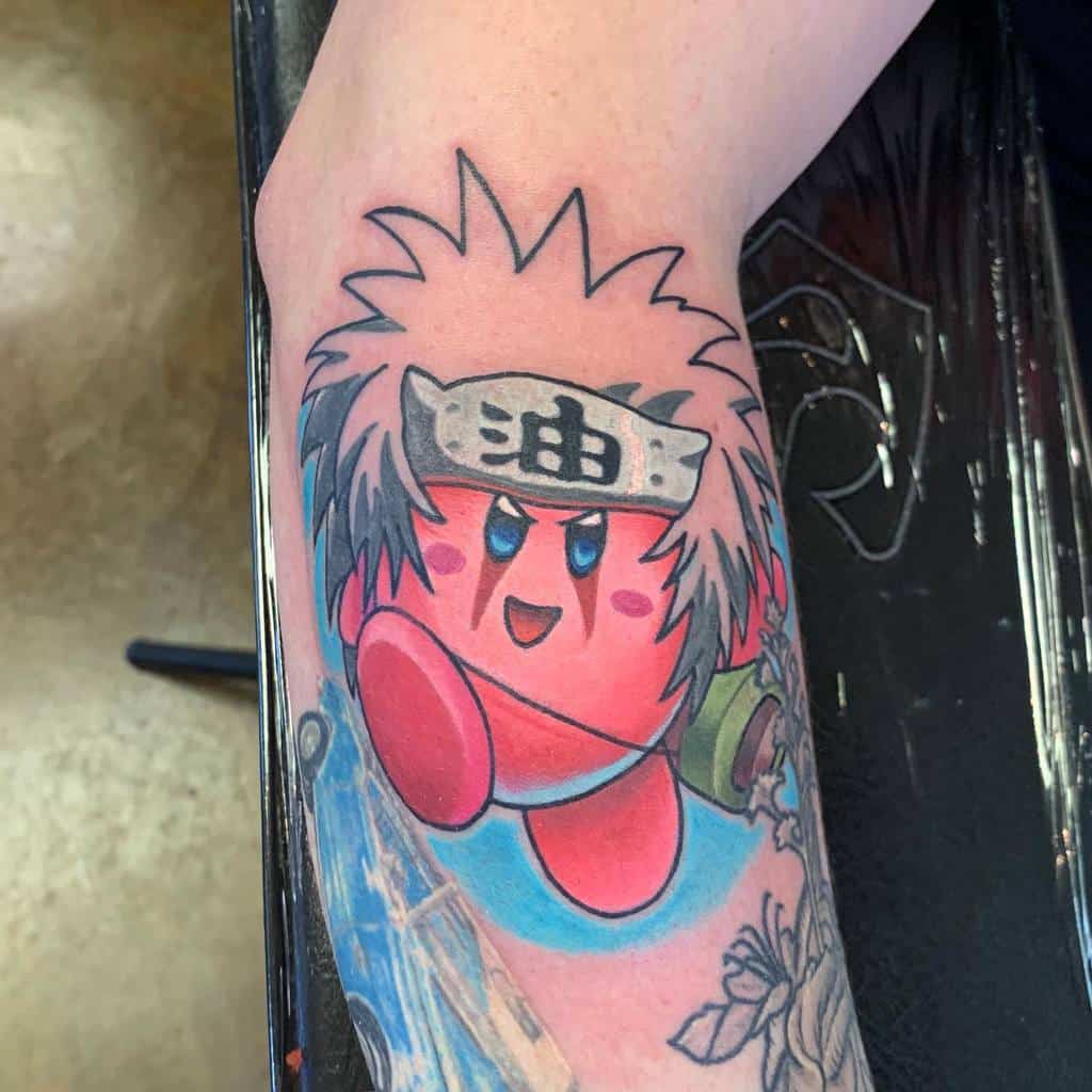 Kirby tattoo dressed as Jiraiya from Naruto, with spiky white hair, a headband with the oil kanji, and a dynamic pose with blue background