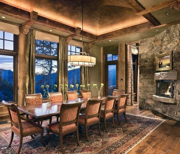 Elegant dining room with crown molding lighting, wooden beams, and a cozy fireplace