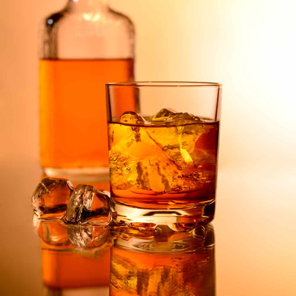 crystal clear ice cubes in whisky glass