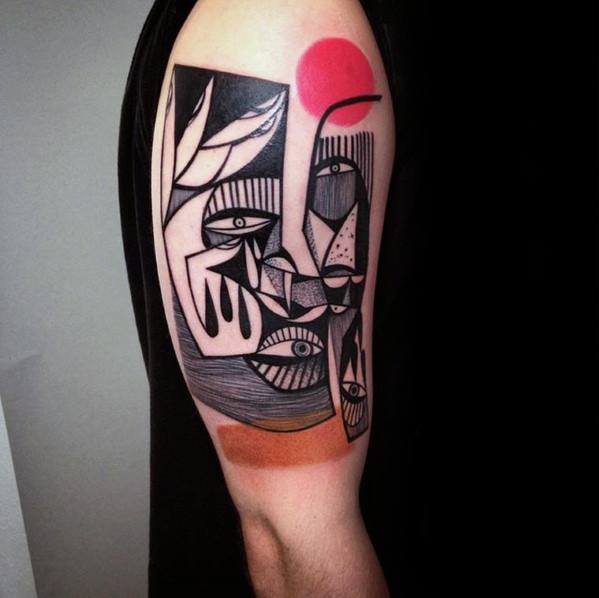 Abstract Cubist tattoo on upper arm featuring surreal faces, multiple eyes, bold black lines, and a striking red sun accent.
