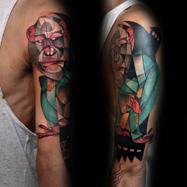Cubist tattoo on upper arm featuring an abstract gorilla in geometric shapes with red, green, and black tones and bold outlines.