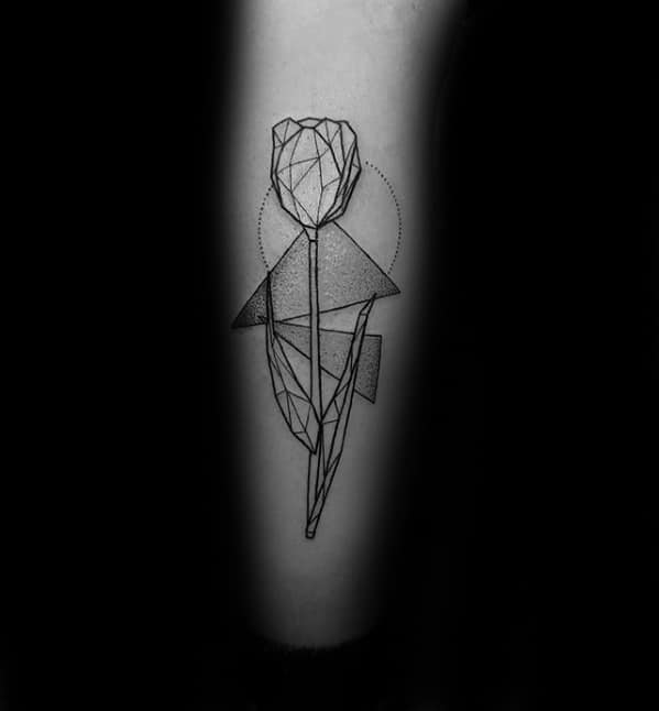 Minimalist Cubist tattoo of a geometric rose with angular lines and shaded shapes, placed on the forearm in black ink.