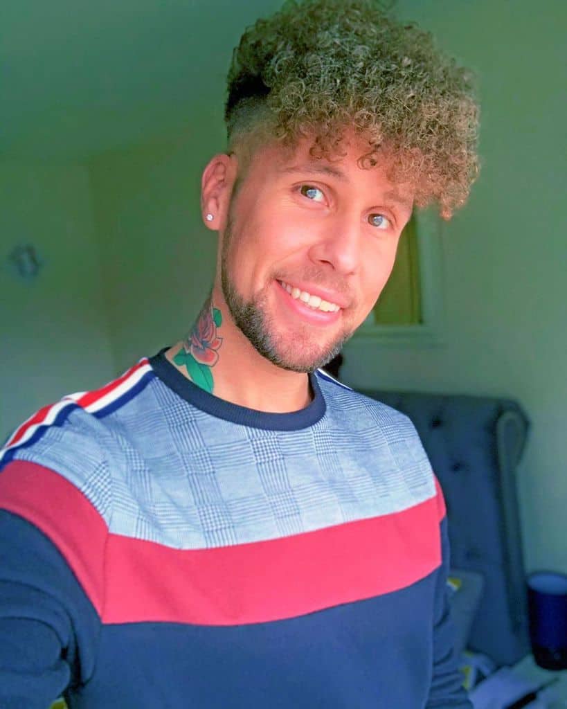 3C hairstyle for men featuring long fringe in front falling on the forehead and short hair on the sides and back