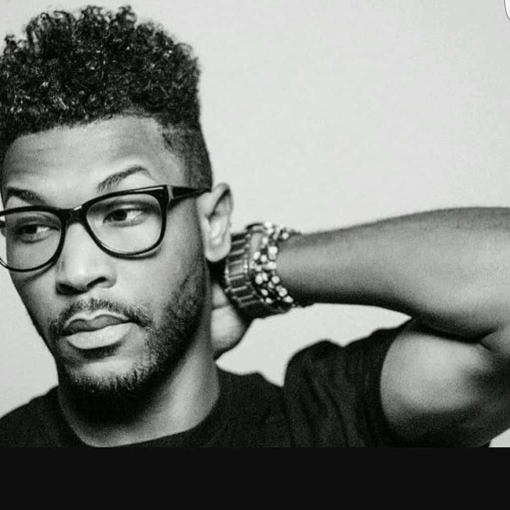 A type 3C curly hair with long curls on top and shaved sides and back. It is a low maintenance look