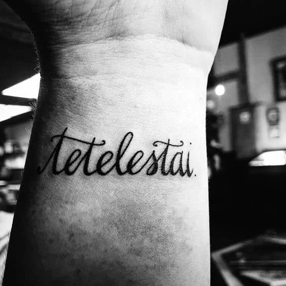 Cursive Tetelestai Guys Wrist Tattoos