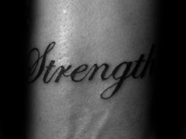 Cursive Wrist Strength Tattoo On Male