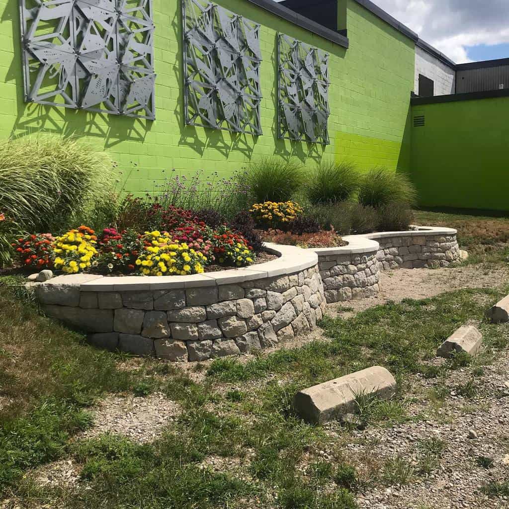 green painted brick wall curved stone garden wall