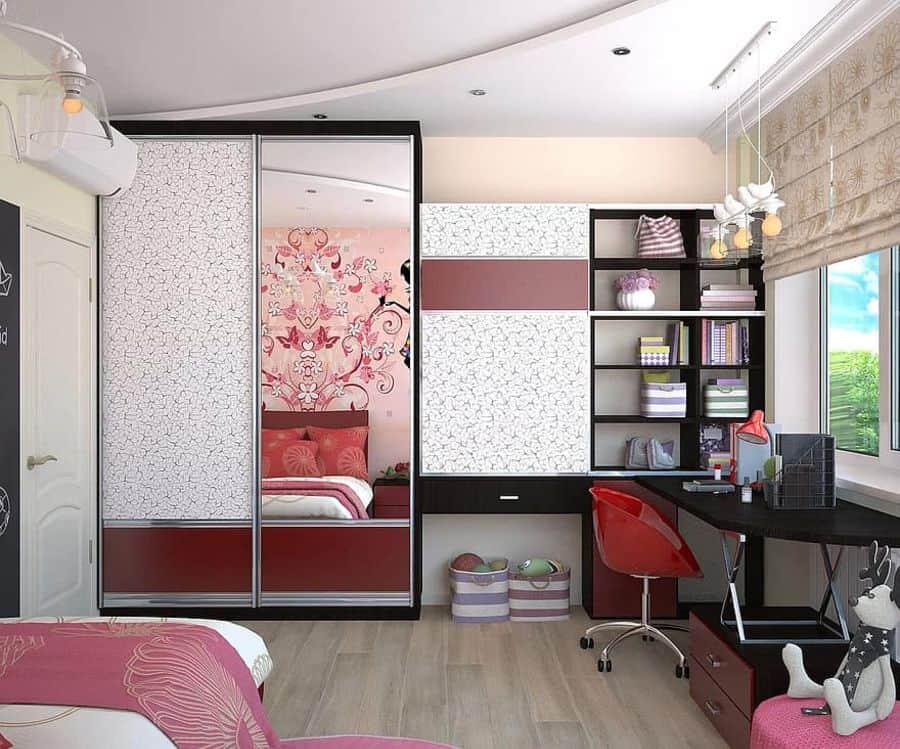 Girl's bedroom with floral wallpaper, sliding wardrobe, and study desk.