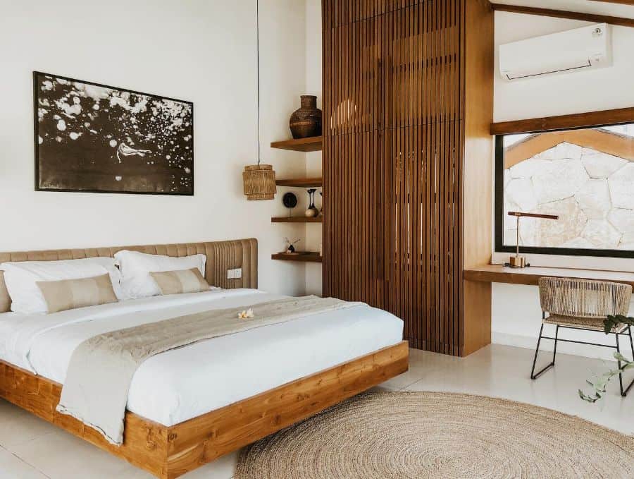 Modern villa bedroom with wooden bed frame and slatted closet.