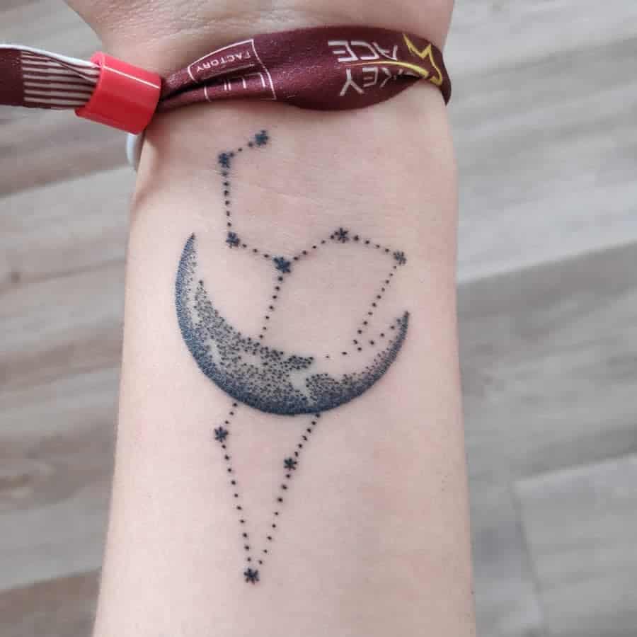 Artistic Leo tattoo with a celestial crescent moon and dotwork stars, creating a dreamy cosmic design.