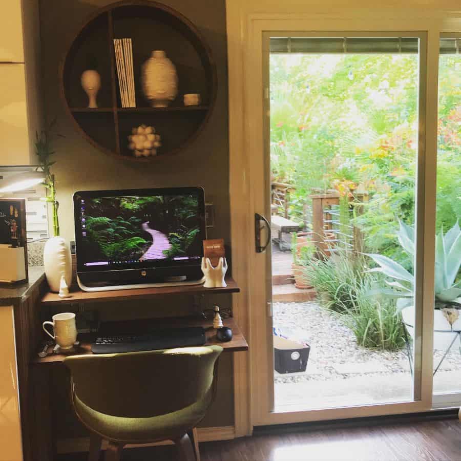 custom home office space in kitchen green chair wall shelving 