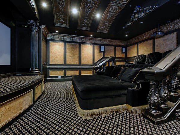 Luxurious home theater with an ornate ceiling, plush seating, and a large screen creates the ultimate viewing experience