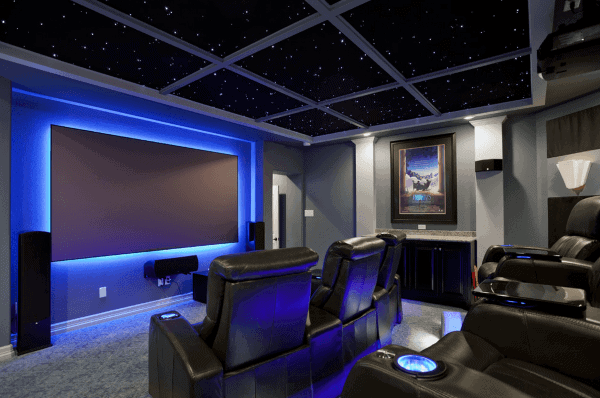 Home theater with black leather recliners, a large screen, blue accent lighting, and a starry ceiling