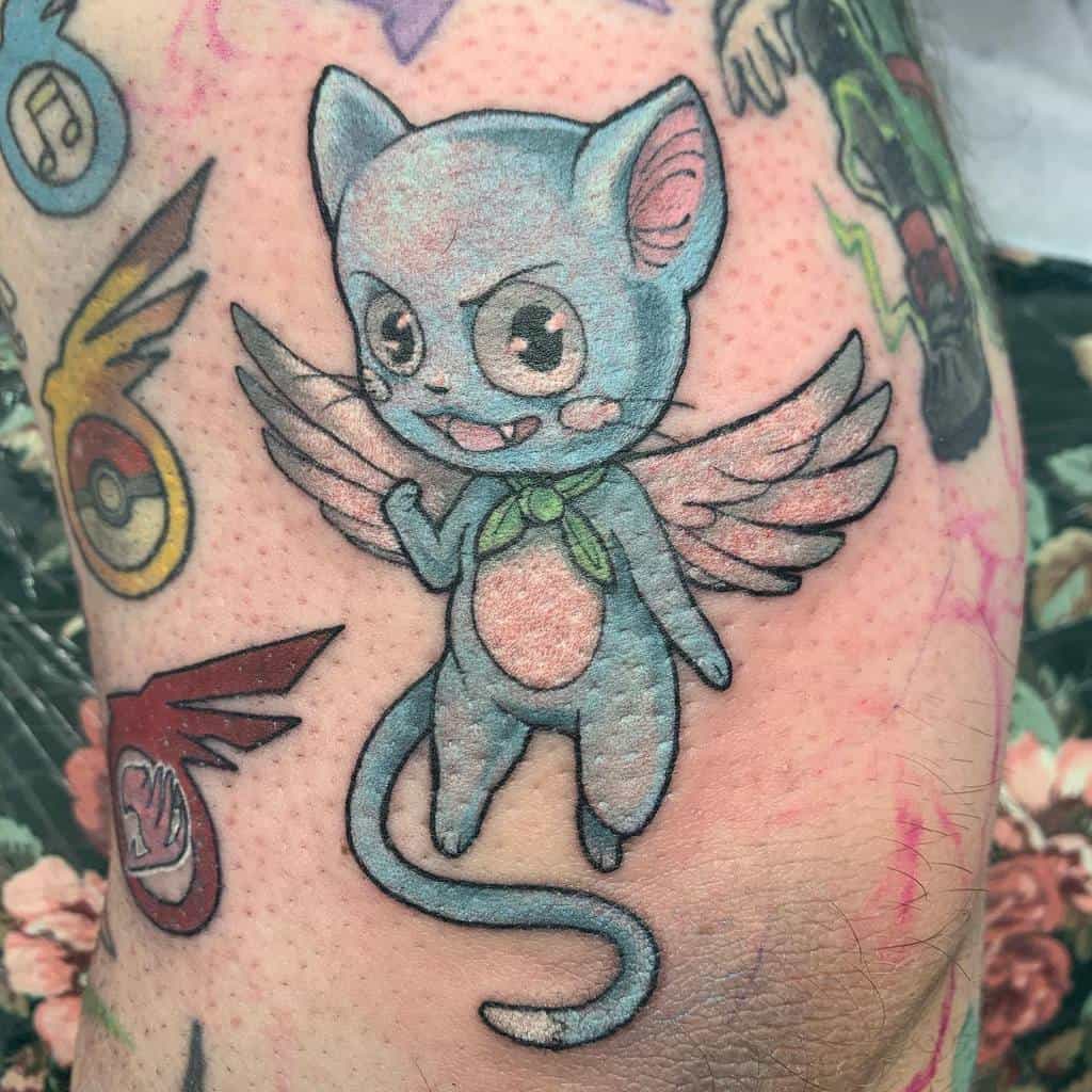 This tattoo showcases Happy from *Fairy Tail* with his wings outstretched, surrounded by various colorful symbols, including Pokémon badges.