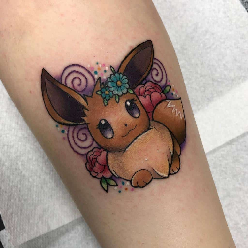 Whimsical Eevee tattoo with a flower crown, vibrant roses, and swirls, creating a colorful and playful design