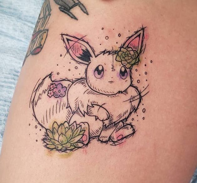 Delicate Eevee tattoo with sketch-style lines, adorned with succulents and flowers for a unique, artistic look