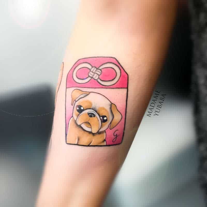 Colorful tattoo of a cute pug inside a pink Japanese-style charm