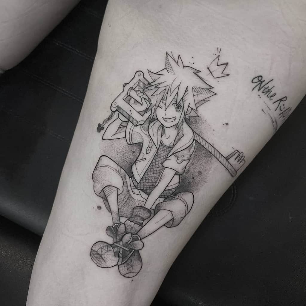 Black ink tattoo of Sora from Kingdom Hearts sitting with a Keyblade, smiling, with a crown above his head, done in a sketchy style.