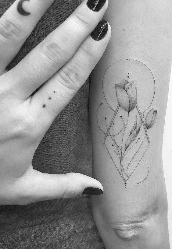 geometric tulip tattoo on the forearm, with elegant lines, dots, and circular elements, creating a modern and artistic design.