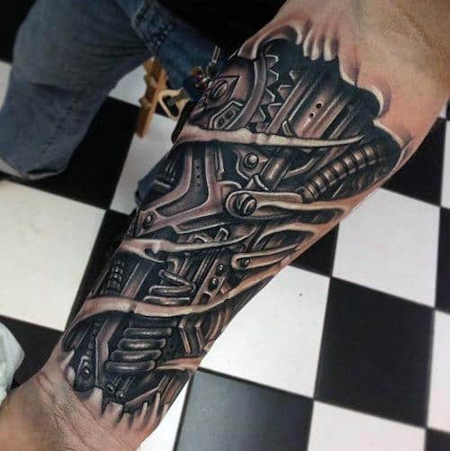 Close-up of a mechanical-looking tattoo on a forearm