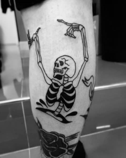 Dancing skeleton tattoo emerging from the ground with raised arms and bold black shading, creating a striking and rebellious design.