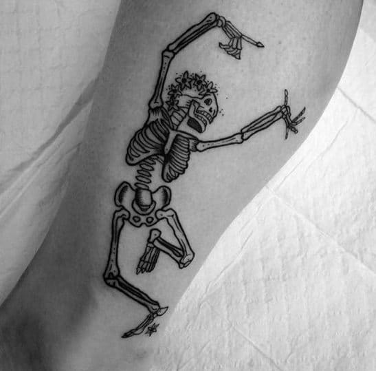 Dancing skeleton tattoo with a playful pose, curly hair, and expressive hands, adding a unique and lively touch to the design.