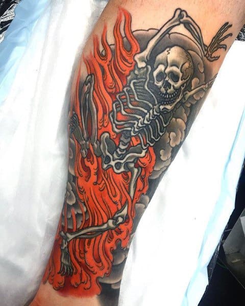 Dancing skeleton tattoo with bold shading, surrounded by swirling flames and smoke, creating a striking and intense visual effect.