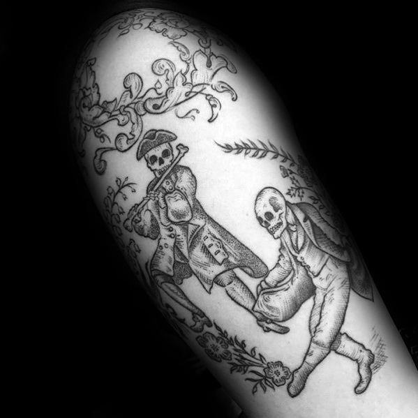Elegant skeleton tattoo featuring two skeletons in vintage attire, one playing a flute while leading the other in a dance, framed by floral details.