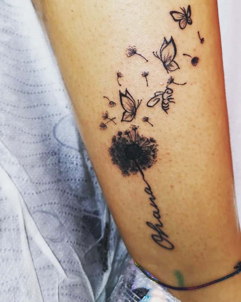 Delicate 'Ohana' tattoo with a dandelion, butterflies, and a bee, symbolizing family, growth, and the beauty of change.