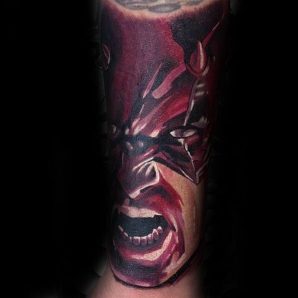 Fierce Daredevil tattoo with a close-up of his angry expression, sharp red tones, and dramatic comic-style shading.