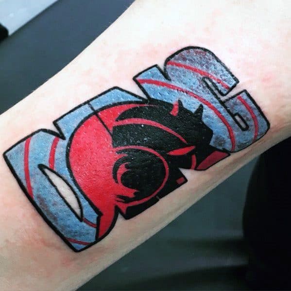 Bold Daredevil tattoo with his silhouette inside stylized comic lettering, featuring red, black, and blue tones for a modern look.
