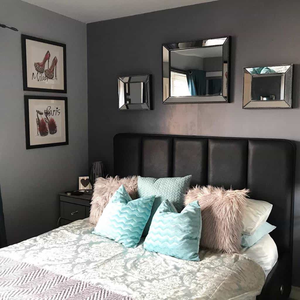 New York-style apartment bedroom with black headboard, mirrored wall decor, and chic pillows.