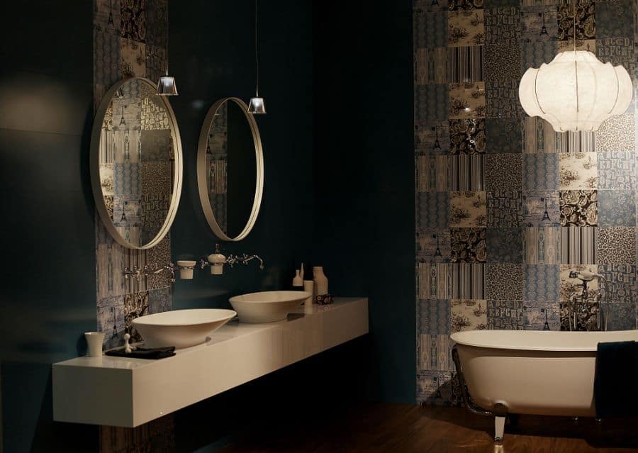 Dark bathroom with patterned wallpaper, double vanity, and freestanding white tub.