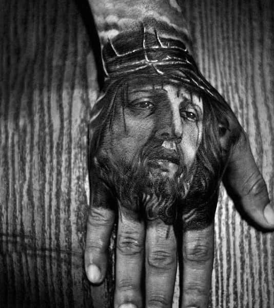 Dark Black And Grey Jesus Face Hand Tattoo For Men