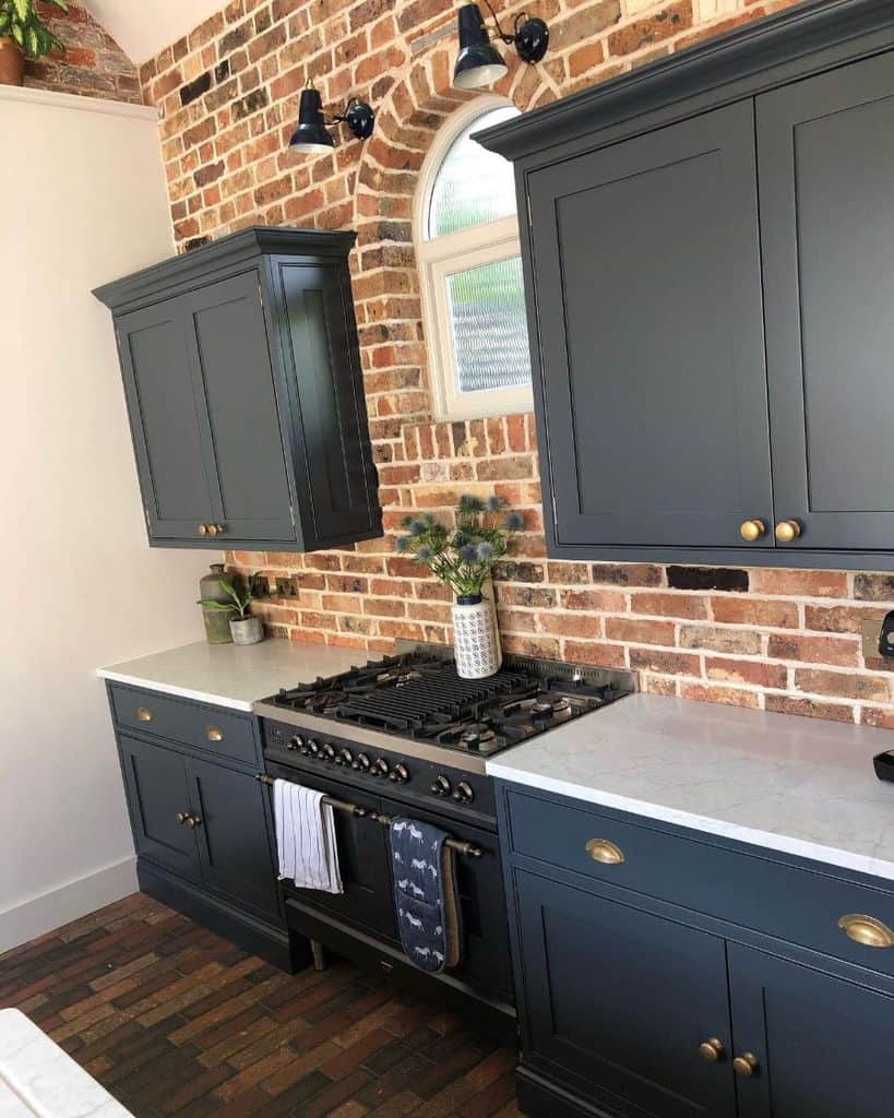 brick accent wall gray cabinets country kitchen